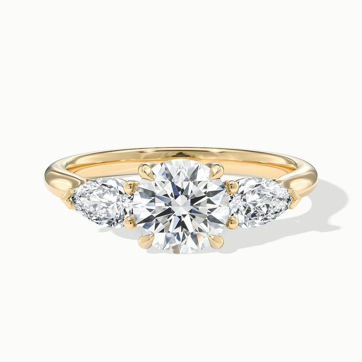 Amaya 2 Carat Round 3 Stone Moissanite Diamond Ring With Pear Side Stone in 10k Yellow Gold